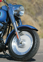 Harley's suspension is slightly harsh but adequately damped.